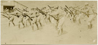 Soldiers Practicing Rifle Moves in an Open Area While Others Observe by Carl Michel